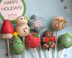 there are many christmas cake pops on the stick