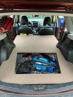 the back end of a car with its trunk open and tools in it's cargo compartment