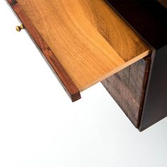 a close up of a wooden drawer with two drawers on one side and an open drawer on the other