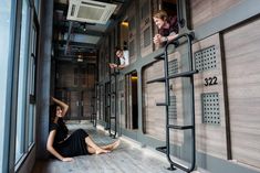 two women sitting on the floor next to each other in a room with wooden walls