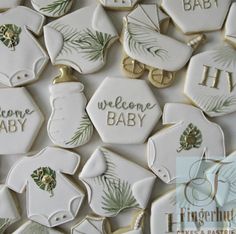 decorated cookies with welcome baby written on them are displayed in front of a white background