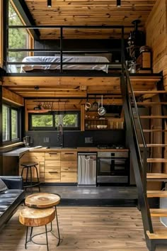 the interior of a tiny cabin with wood floors and stairs