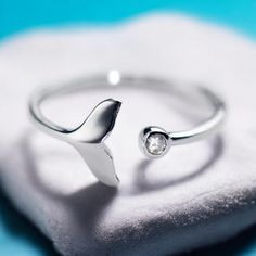 🌊 Adjustable 925 Sterling Silver Whale Tail Ring with Zirconia - Tarnish-Resistant Ocean-Inspired Elegance 🌊 Dive into timeless style with this stunning adjustable 925 Sterling Silver ring featuring a graceful whale tail on one end and a sparkling Zirconia on the other. This ocean-inspired ring is not only tarnish-resistant but also crafted to suit any finger with its adjustable design. Perfect for ocean lovers, this piece adds a touch of nature's beauty to your jewelry collection. 💍 Why You'll Love This Ring: ✨ Premium Quality: Made from 925 Sterling Silver for a lasting, tarnish-free shine. 🐋 Unique Whale Tail Design: Showcasing the beauty of the ocean with a delicate whale tail on one end. 💎 Sparkling Zirconia Accent: Adds a touch of elegance and sparkle to your everyday look. 🌍 W Whale Ring Silver, Whale Jewelry, Ocean Inspired Jewelry, Zirconia Rings, Ocean Jewelry, Whale Tail, Ocean Inspired, Ocean Inspiration, Nature's Beauty