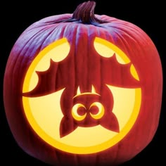 a carved pumpkin with an image of a bat on it