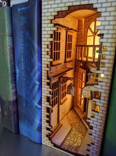 two books on a shelf next to each other with an image of a house in the middle