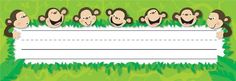 monkeys holding up a blank sign in front of green grass with white paper for writing