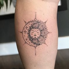 a sun and moon tattoo on the leg