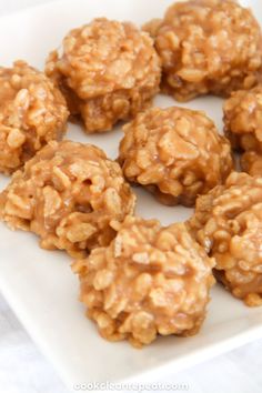 a white plate topped with cookies covered in oatmeal flakes on top of a table