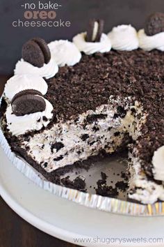 a chocolate cake with oreo cookies and cream frosting is on a white plate