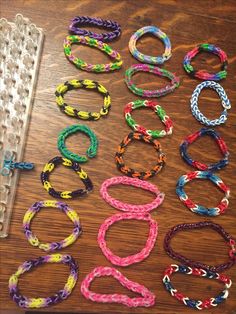 several different colored bracelets sitting on top of a wooden table