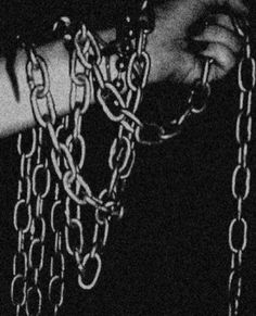 black and white photograph of hands holding chains