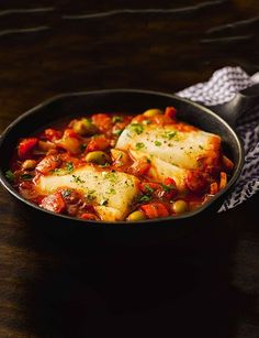 a pan filled with food on top of a wooden table