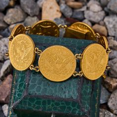 This fantastic vintage coin bracelet features seven $5 gold Liberty Head American coins from 1901, 1907, 1895, 1903, 1893, 1900, and 1892 that are attached with 14k yellow gold links and hidden box clasp. The bracelet features a safety chain and it comfortably fits up to a 6.25 inch wrist. The coins are in good shape with the eagle side is facing out. Gold Coins Bracelet, Vintage Jewelry Antique, American Coins, Coin Bracelet, Gold Coins, Garnet Rings, Gold Accents, High Quality Jewelry, Estate Jewelry