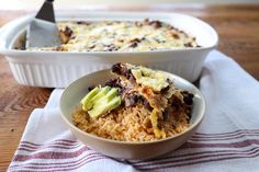 a casserole dish with an avocado on top and a serving spoon