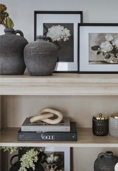 two vases are sitting on top of the bookshelves in this living room