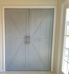 an empty room with two doors and tile flooring