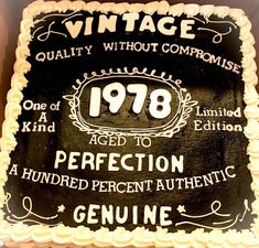 a black and white birthday cake with an aged to perfection sign on it's side