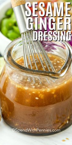 homemade sesame ginger dressing in a glass jar with a whisk