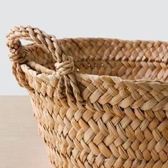 a woven basket sitting on top of a wooden table