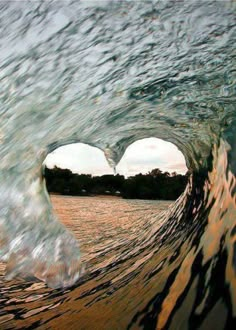 the inside of a wave that is in the water with its heart shaped hole at the end