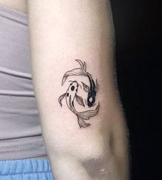 a woman's arm with a fish tattoo on it