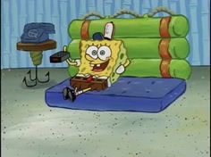 a spongebob sitting on top of a blue mattress