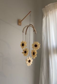 a sunflower mobile hanging from a wall