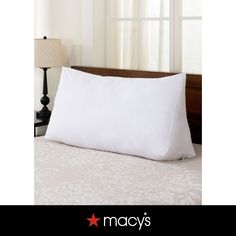 a white pillow sitting on top of a bed