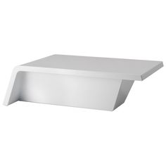 a white shelf that is on top of a wall and has an open end in the middle