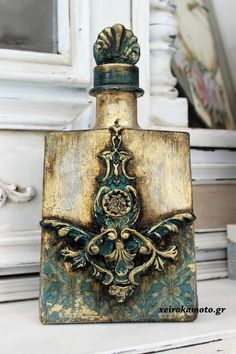 an old fashioned flask bottle is sitting on a white table with a mirror in the background