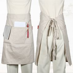 two aprons with pockets on each side and a pen sticking out of the pocket