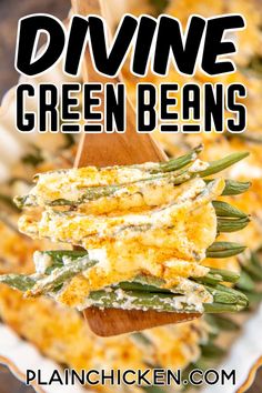 a wooden spoon filled with green beans on top of a white plate topped with cheese