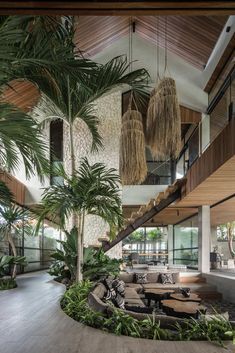 an indoor living area with palm trees and couches