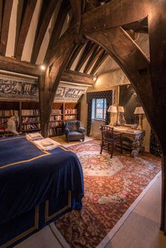 a bedroom with a bed, desk and bookshelf inside of it on top of a rug