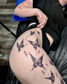 a woman with tattoos on her thigh and leg