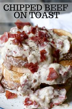 a white plate topped with bread covered in cheese and bacon