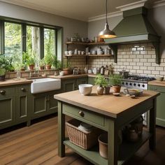 a kitchen filled with lots of green cabinets and counter top next to a stove top oven