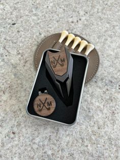 a couple of wooden items sitting in a metal container on top of a counter next to a bottle opener