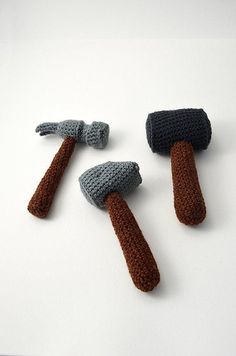 three crocheted hammers are shown on a white surface