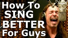 a man singing into a microphone with the words how to sing better for guys on it