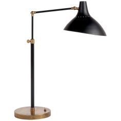 a black and gold desk lamp on a wooden base with an adjustable arm, the light is