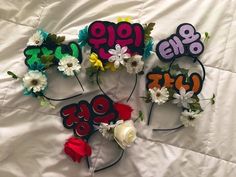 five flower headbands with the numbers 99, 90, and 95 on them