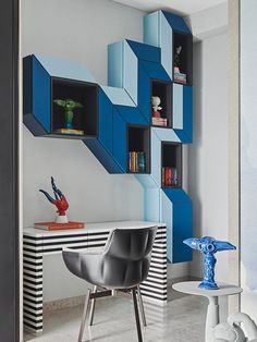 a room that has some shelves on the wall and a chair in front of it