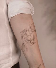 a woman's arm with a tattoo on it that has two flowers in the middle