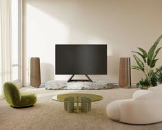 a large flat screen tv sitting on top of a wooden stand in a living room