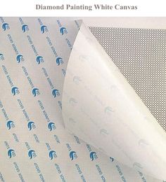 a roll of white paper on top of a sheet of blue and white patterned paper