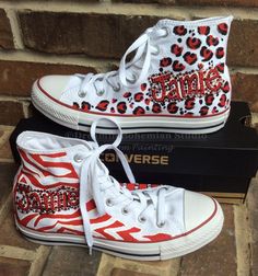 Zebra and Leopard Print Chuck Taylor Hi Tops hand painted in school colors personalized with your students name and appropriate color bling. A client of mine saw my Handpainted Diva Converse Hi Top Shoe design here https://www.etsy.com/listing/482182751/custom-pink-converse-custom-converse?ref=shop_home_active_40 and loved them and wanted some for her niece and wanted some in her school colors of Boomer Red and White. I added matching bling and here we go, School Spirit Shoes! You can get them w Mj Homecoming, School Spirit Shoes, Spirit Overalls, Hand Painted Converse, Converse Hi Top, Personalized Converse, Homecoming 2022, Painted Converse, Color Converse