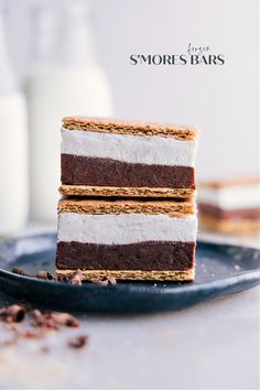 three pieces of chocolate and white cake on a plate with milk in the back ground