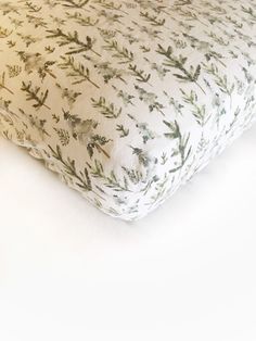 a close up of a pillow on a white surface