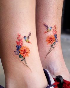 two small tattoos with flowers and birds on their legs